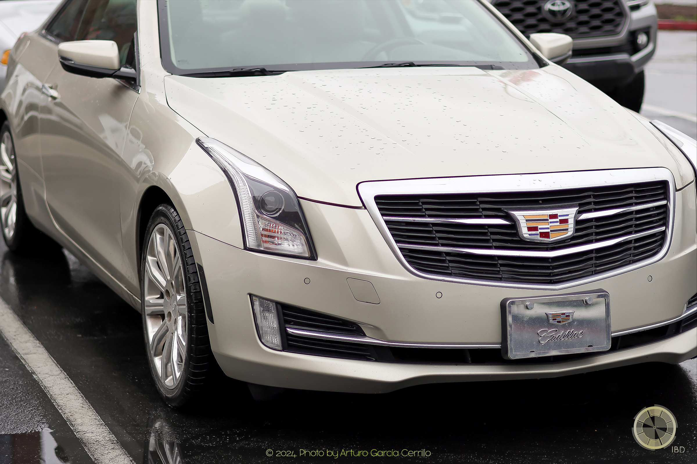 Picture of golden cadillac parked front-side view