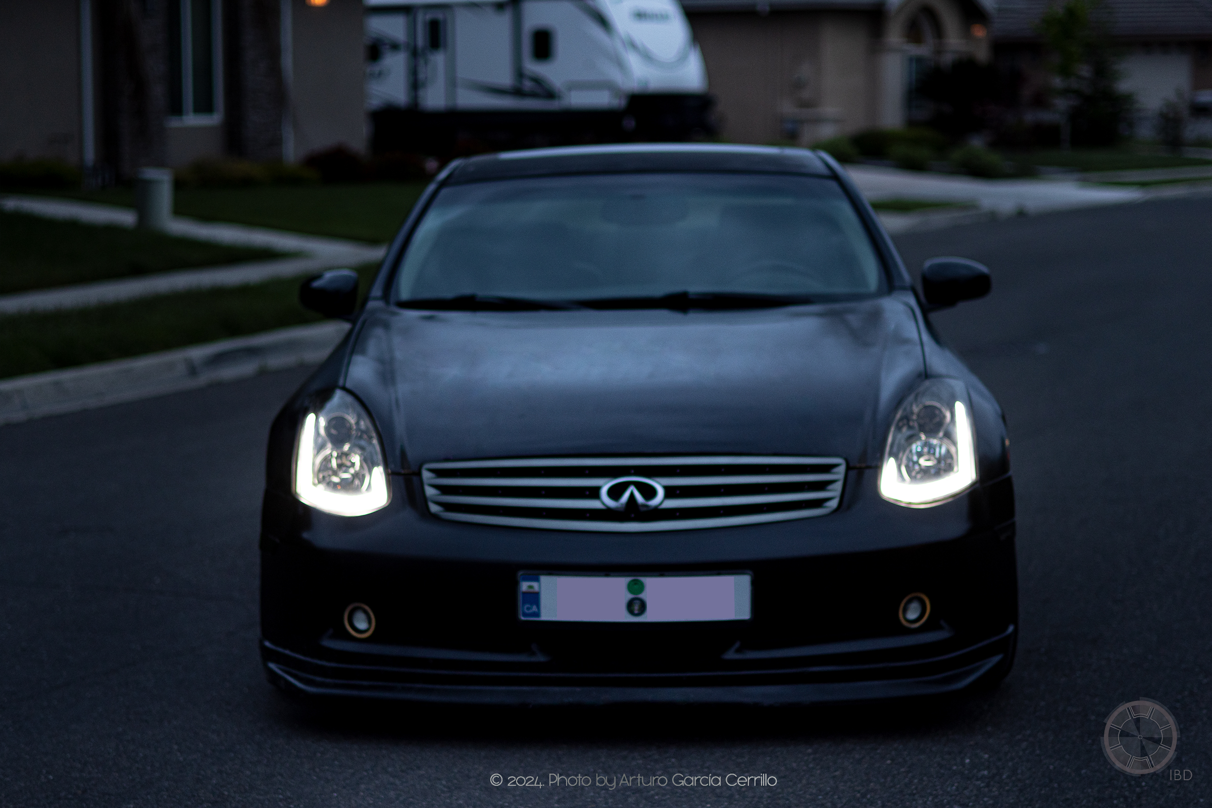 Picture of a black infinity car stopped in middle of street