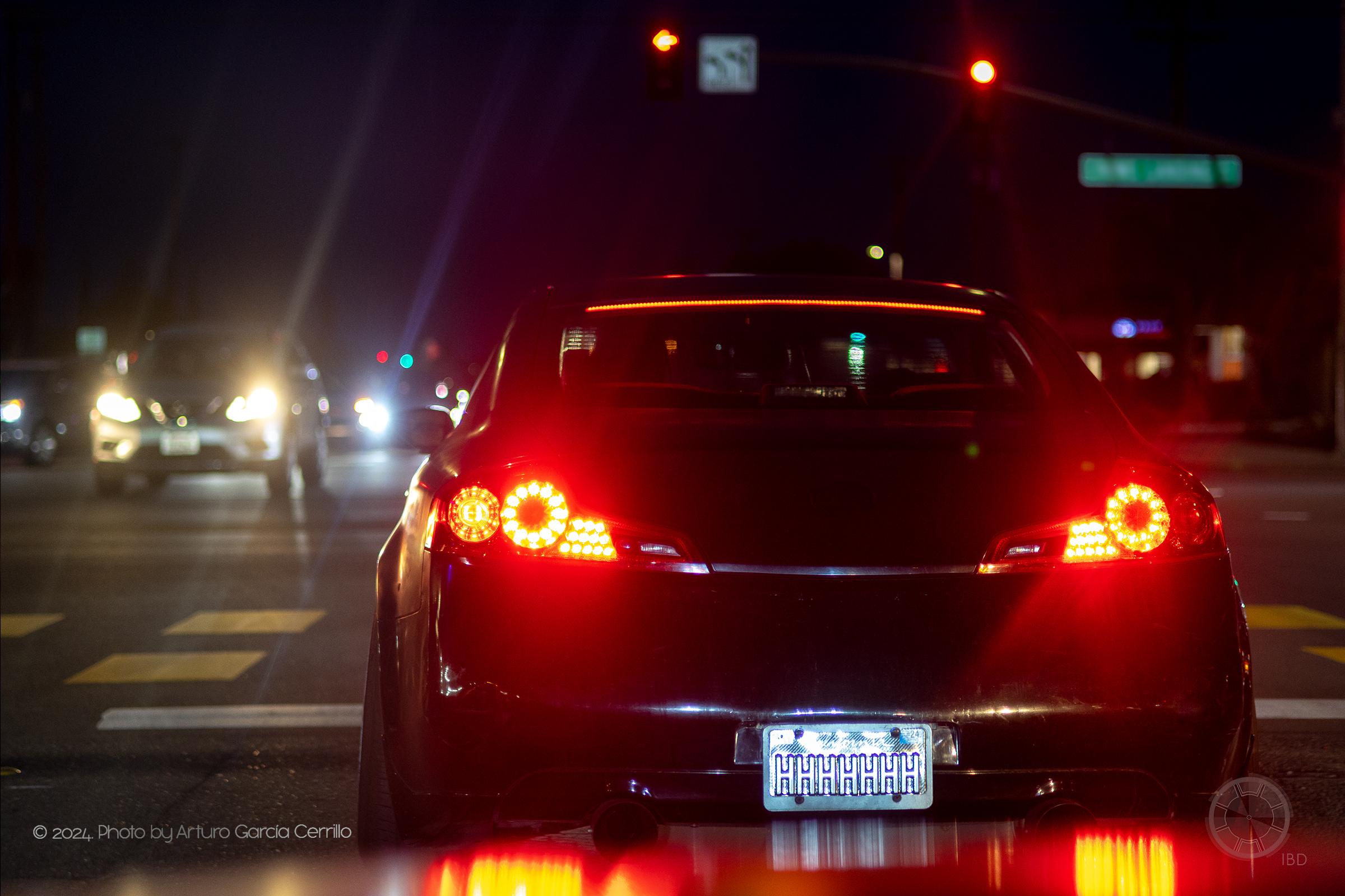 Picture of a black infinity car driving at night