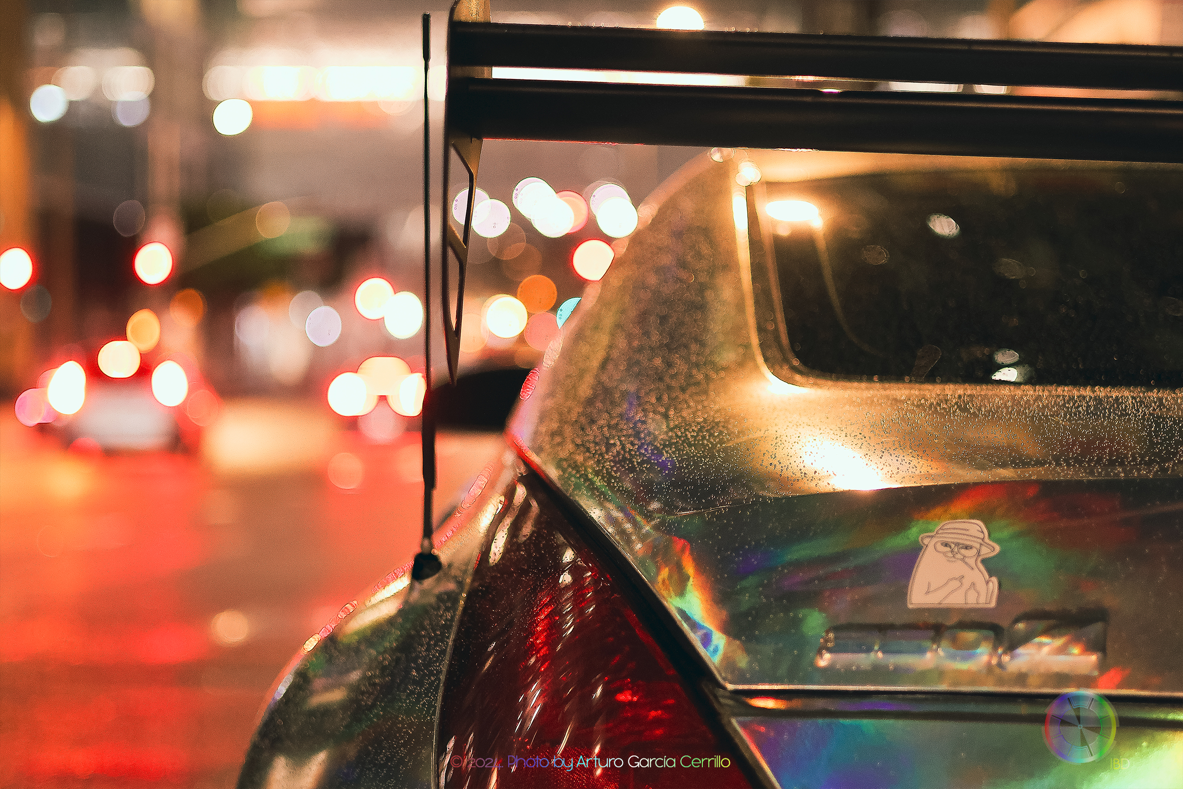 Picture of a holographic wrap nissan 350z at night with red tones