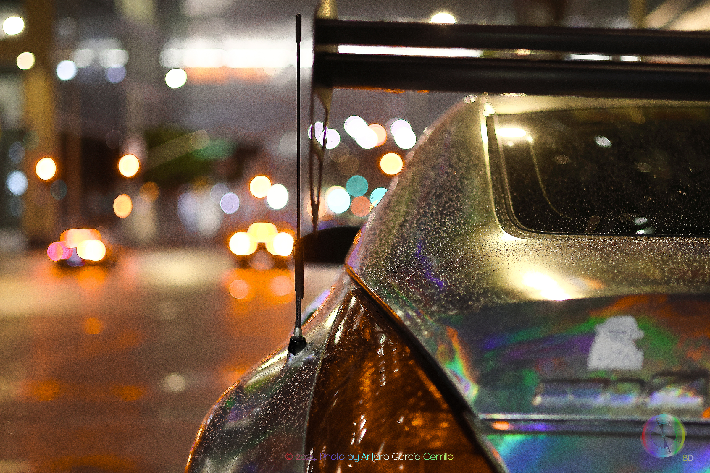 Picture of a holographic wrap nissan 350z at night with warm lights