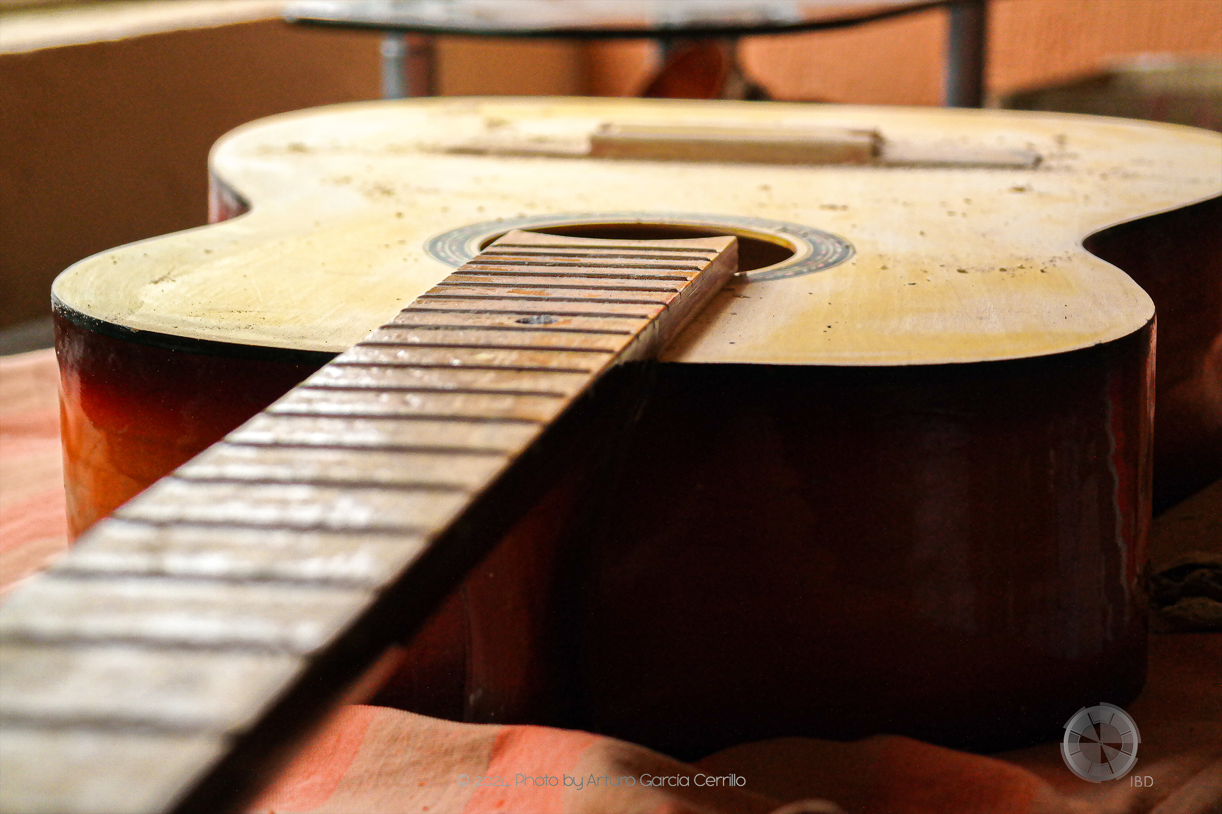 Picture of yellow acoustic guitar without strings.