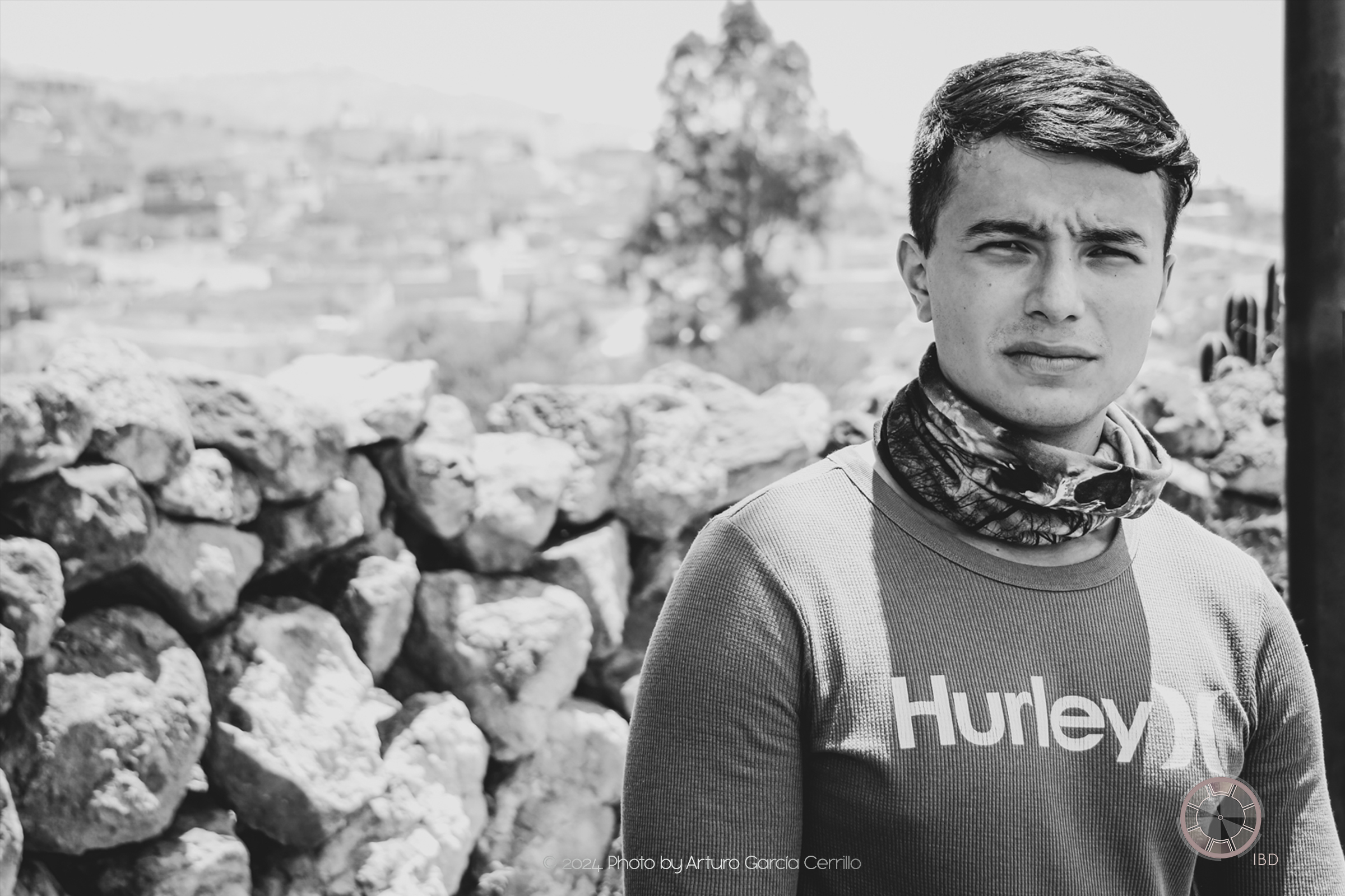 Grayscale portrait of guy at dry landscape