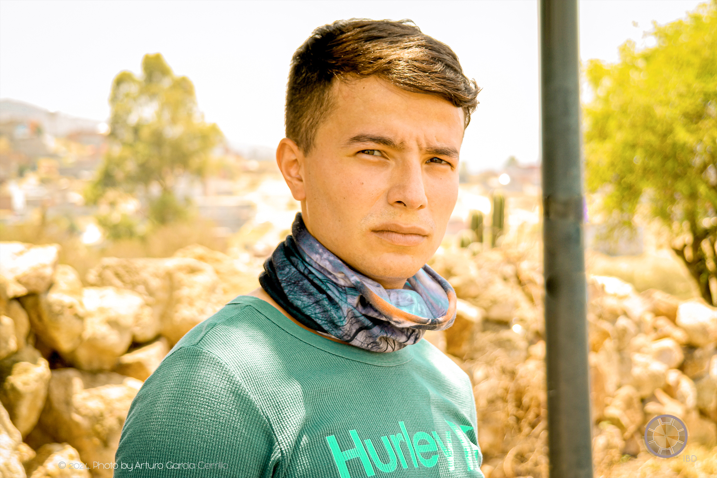 Portrait of guy with green shirt with dry landscape