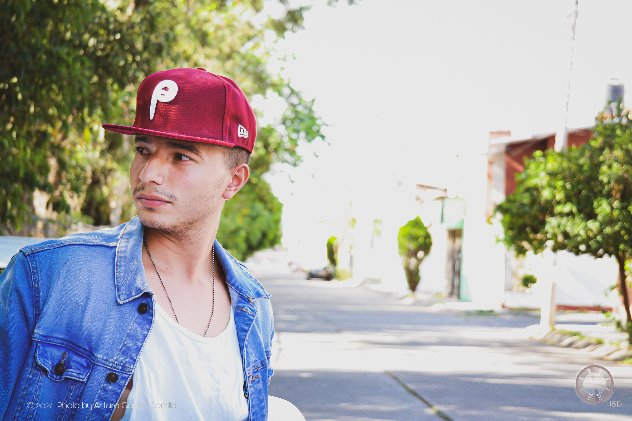 Portrait of guy with maroon hat looking to the side