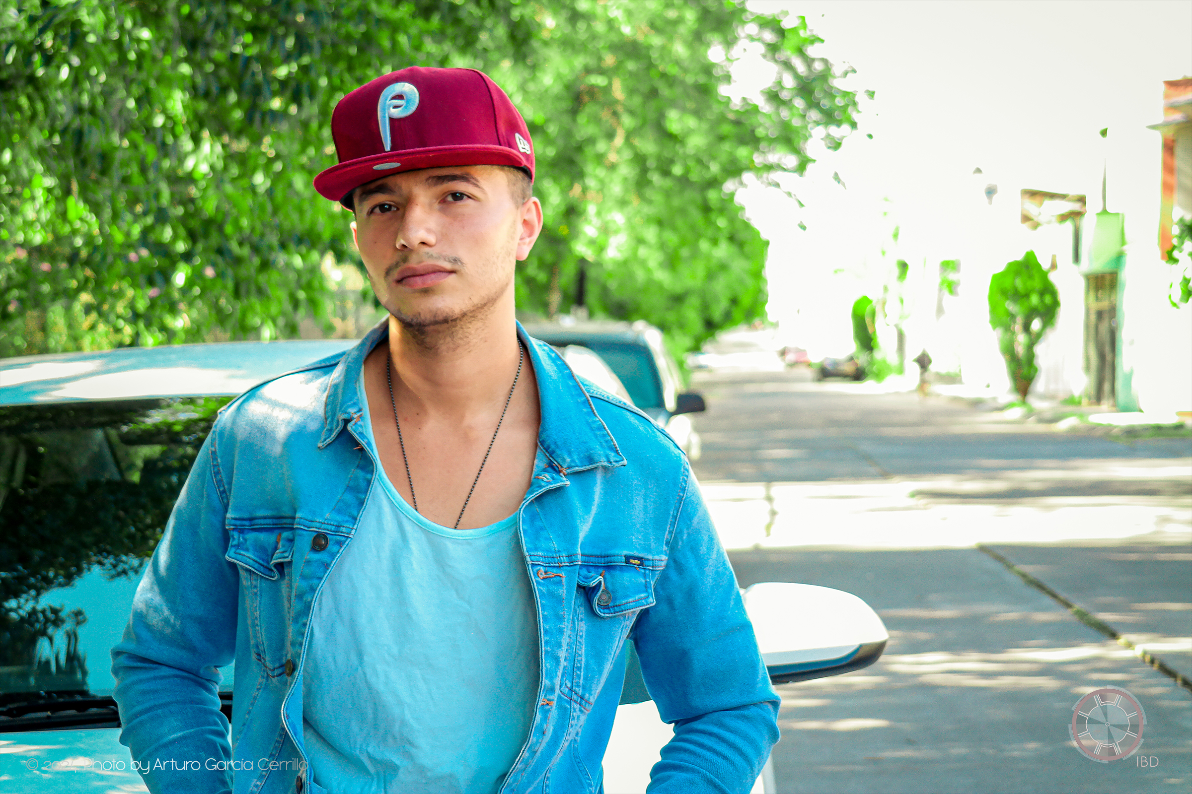 Portrait of guy with maroon hat looking at camera