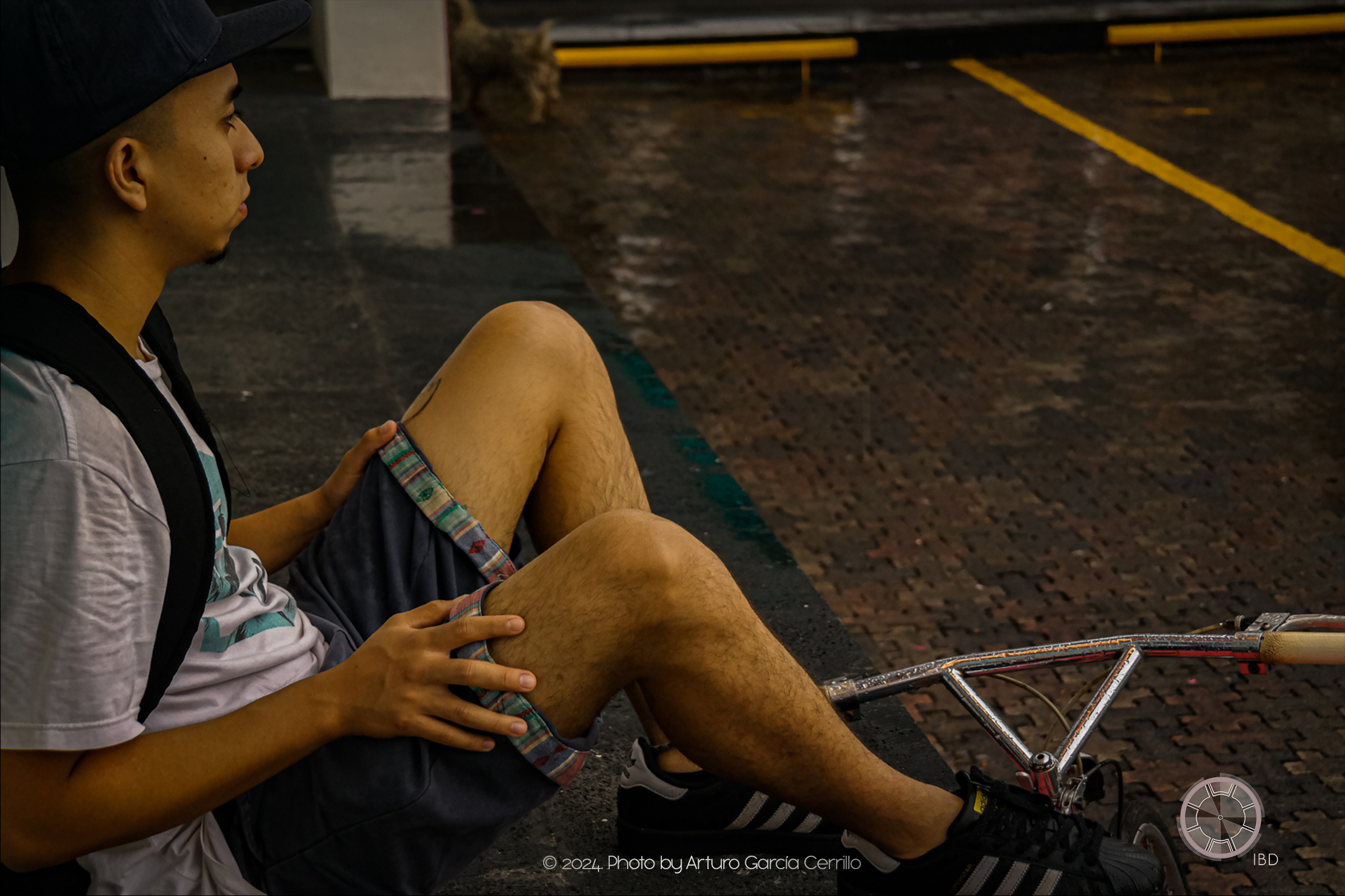 Portrait of guy sitting in front of his bycicle