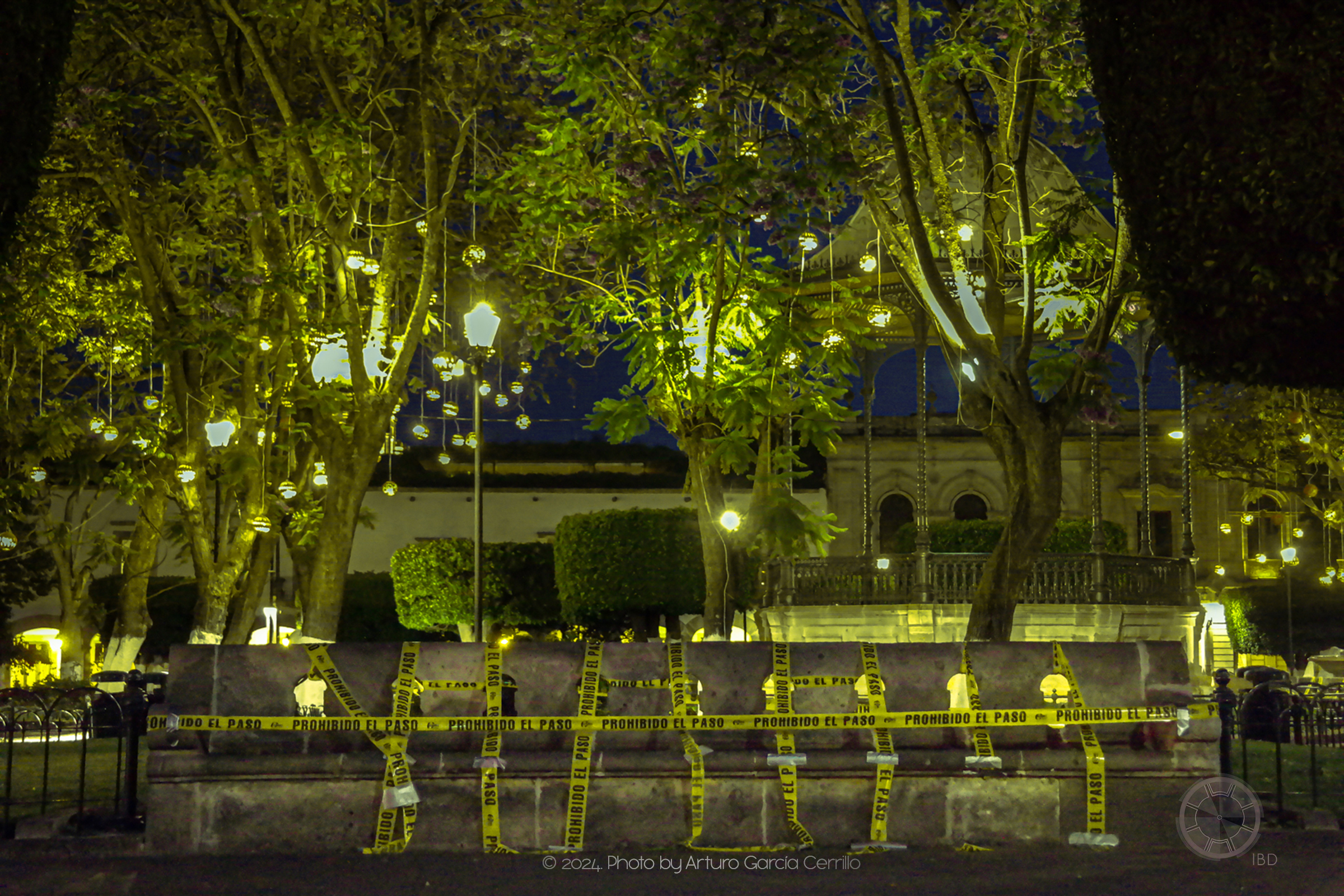 Picture of stone bench restricted with caution tape at night