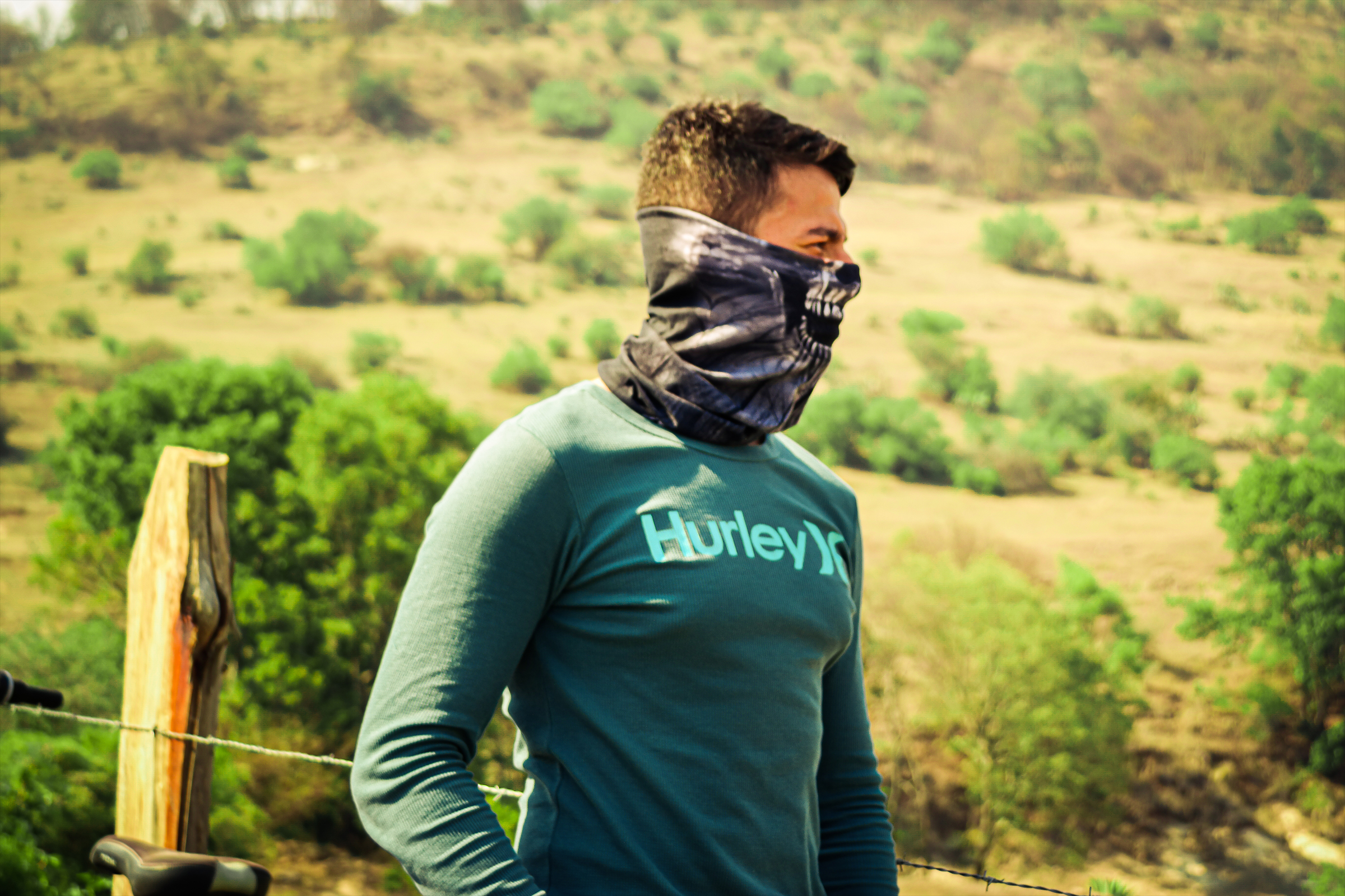 Side portrait of young man posing for picture in high temperature environment