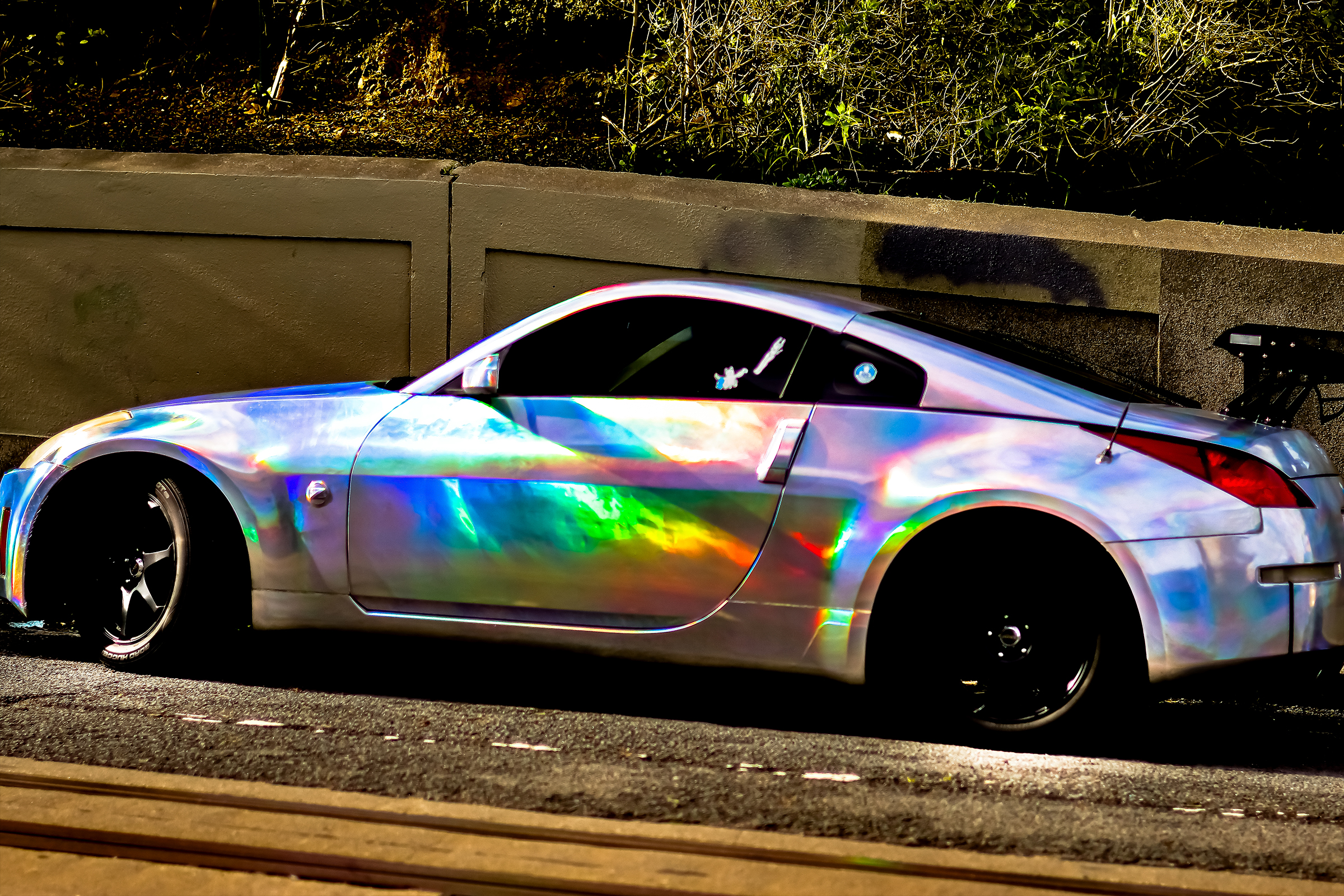 Side view picture of Arturo's nissan 350z with holographic wrap job