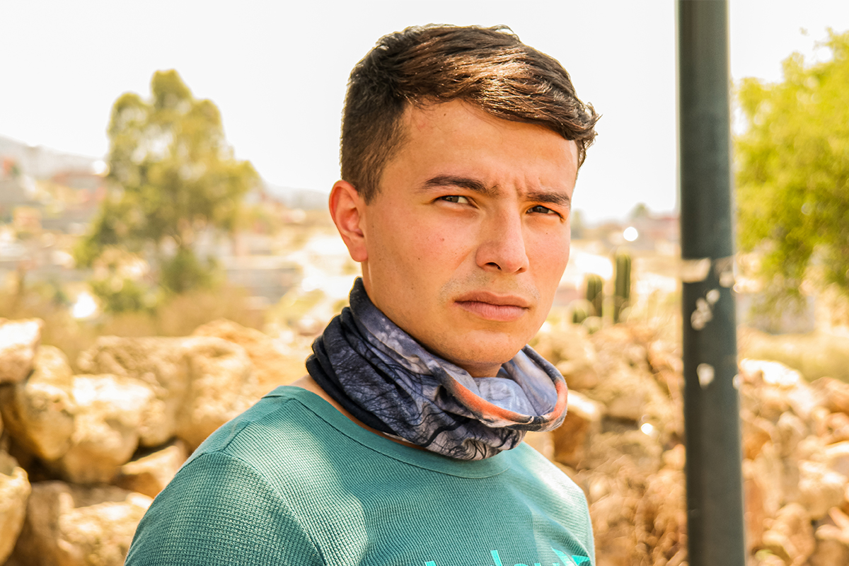 Portrait of young man posing for picture in high temperature environment