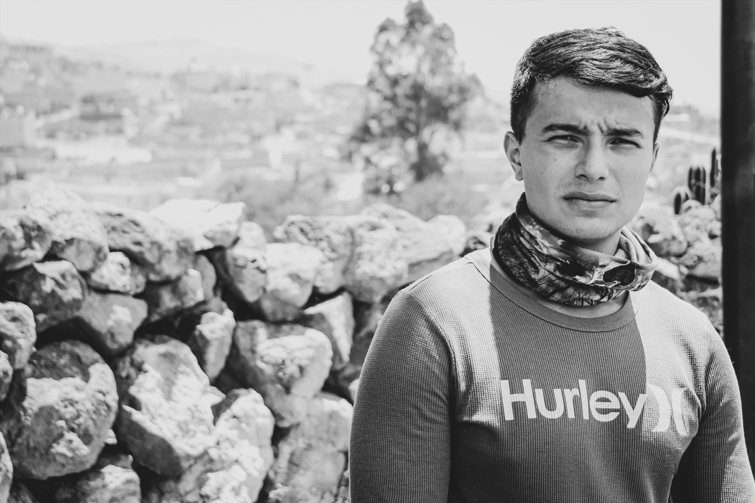 Portrait in black and white of young man posing for picture in high temperature environment